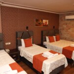 Kalabalık gruplar ve çocuklu aileler için özel olarak tasarlanan 4 kişilik odalarımız, otelimizin en geniş konaklama birimidir. Herkesin kendi konfor alanına sahip olduğu bu odalarda; geniş banyo, fonksiyonel mobilyalar ve yüksek kaliteli tekstil ürünleriyle keyifli bir konaklama sizi bekliyor. Birlikte seyahat etmenin tadını, konfordan ödün vermeden çıkarın.