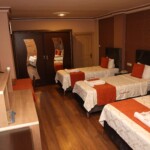 Kalabalık gruplar ve çocuklu aileler için özel olarak tasarlanan 4 kişilik odalarımız, otelimizin en geniş konaklama birimidir. Herkesin kendi konfor alanına sahip olduğu bu odalarda; geniş banyo, fonksiyonel mobilyalar ve yüksek kaliteli tekstil ürünleriyle keyifli bir konaklama sizi bekliyor. Birlikte seyahat etmenin tadını, konfordan ödün vermeden çıkarın.